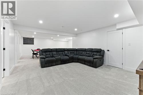 Living room with light carpet and recessed lighting - 9 Macneil Court, Port Burwell, ON - Indoor