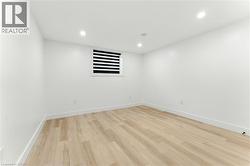 Unfurnished room with light wood-type flooring and recessed lighting - 