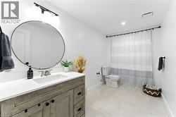 Full bath with vanity, a shower with curtain, light tile patterned floors, and recessed lighting - 