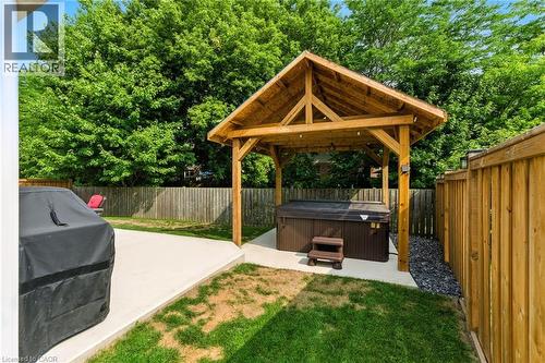Fenced backyard with a hot tub and a patio - 9 Macneil Court, Port Burwell, ON - Outdoor With Deck Patio Veranda With Backyard