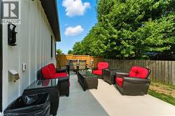 Fenced backyard with outdoor lounge area and a patio - 