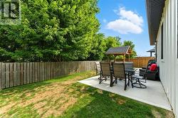Fenced backyard with a patio and outdoor dining area - 