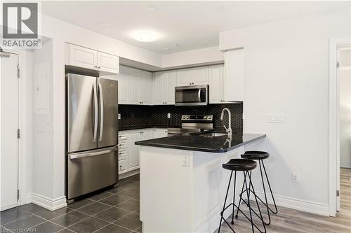 1045 Nadalin Heights Unit# 108, Milton, ON - Indoor Photo Showing Kitchen With Stainless Steel Kitchen With Double Sink