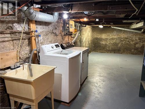 unfinished basement laundry and tub - 261 Prospect Street S, Hamilton, ON - Indoor Photo Showing Laundry Room
