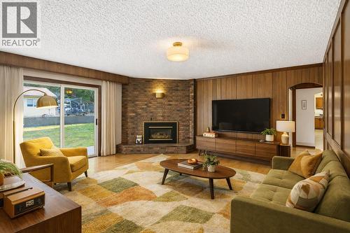 *virtually staged for illustrative purposes - 1099 Dehart Road, Kelowna, BC - Indoor Photo Showing Living Room With Fireplace