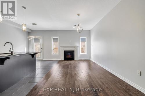 Living room with wood finished floors & fireplace - 89 Sonoma Valley Crescent, Hamilton, ON - Indoor Photo Showing Living Room With Fireplace