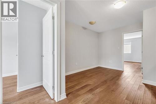 Flex space  with light wood-style flooring and a textured ceiling - 89 Sonoma Valley Crescent, Hamilton, ON - Indoor Photo Showing Other Room