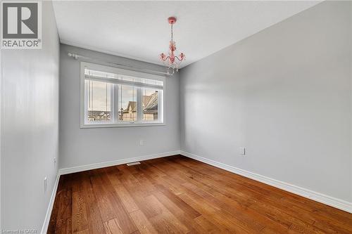 Spare room featuring a chandelier and hardwood / wood-style flooring - 89 Sonoma Valley Crescent, Hamilton, ON - Indoor Photo Showing Other Room