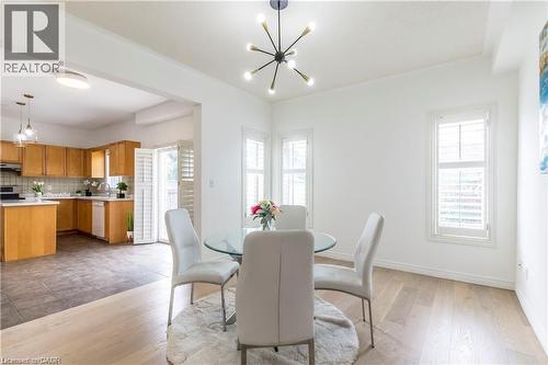 Dining space with hanging lights, light wood finished floors, and plenty of natural light - 252 Thorner Drive Unit# Upper, Hamilton, ON - Indoor Photo Showing Other Room