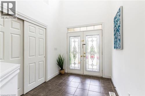 Foyer entrance with dark tile patterned flooring and a high ceiling - 252 Thorner Drive Unit# Upper, Hamilton, ON - Indoor Photo Showing Other Room