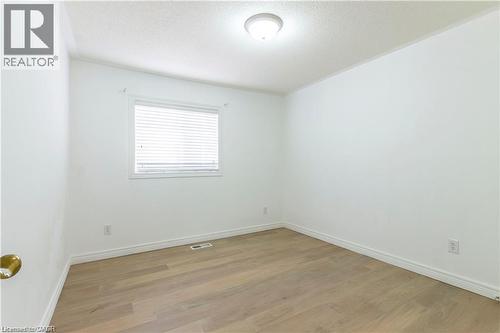Spare room with light wood-style floors and a textured ceiling - 252 Thorner Drive Unit# Upper, Hamilton, ON - Indoor Photo Showing Other Room
