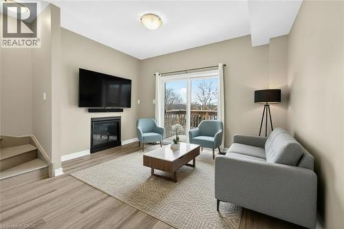 Virtually Staged Living Room With F/P & Walk Out - 48 Markle Crescent, Ancaster, ON - Indoor Photo Showing Living Room With Fireplace