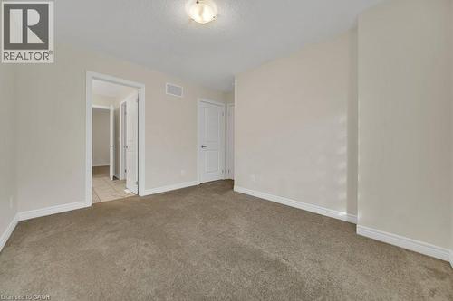 Spare room with light carpet and a textured ceiling - 285 Broadacre Drive, Kitchener, ON - Indoor Photo Showing Other Room