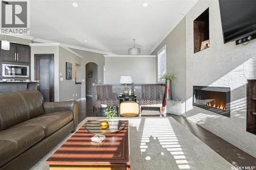 4506 Sandpiper Crescent E, Regina, SK - Indoor Photo Showing Living Room With Fireplace