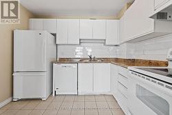 Sizeable kitchen space with lovely backsplash. - 