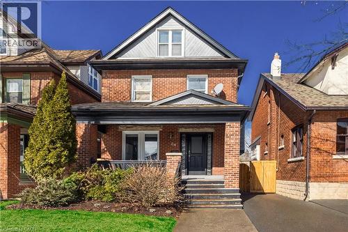 View of front of home with brick siding and covered porch - 84 South Oval, Hamilton, ON - Outdoor