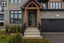 Stone facade with contrasting wood beam entryway - 7 Bartlett Avenue, Grimsby, ON  - Outdoor With Facade 