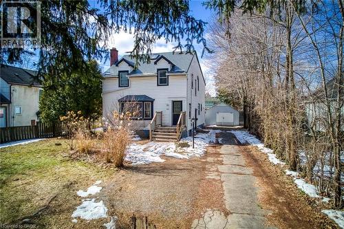Traditional home with a chimney, an outbuilding, a garage, and driveway - 142 Ewen Road, Hamilton, ON - Outdoor