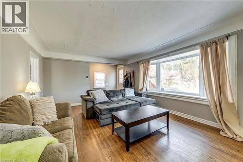 Living room featuring wood finished floors and baseboards - 142 Ewen Road, Hamilton, ON - Indoor Photo Showing Living Room
