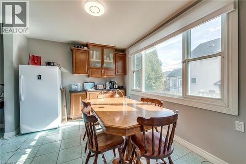 Dining space with light tile patterned floors - 142 Ewen Road, Hamilton, ON - Indoor