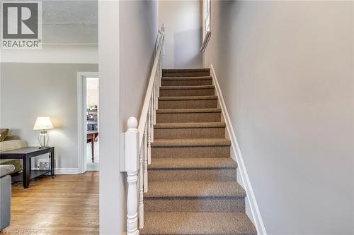Stairs featuring wood finished floors and baseboards - 142 Ewen Road, Hamilton, ON - Indoor Photo Showing Other Room