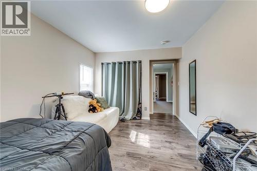 Bedroom featuring wood finished floors and baseboards - 142 Ewen Road, Hamilton, ON - Indoor Photo Showing Bedroom