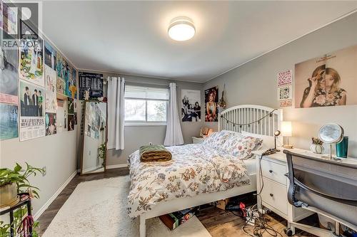 Bedroom featuring dark wood-style floors and baseboards - 142 Ewen Road, Hamilton, ON - Indoor Photo Showing Bedroom
