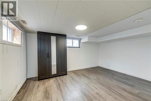 Below grade area with light wood finished floors and baseboards - 142 Ewen Road, Hamilton, ON - Indoor Photo Showing Other Room