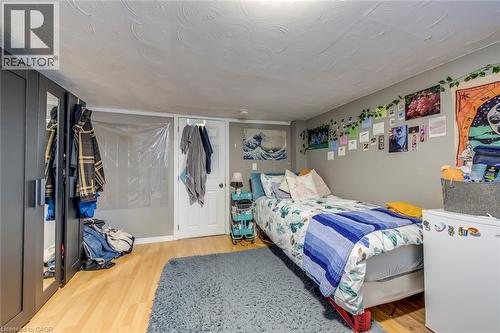 Bedroom with light wood-style floors and a textured ceiling - 142 Ewen Road, Hamilton, ON - Indoor Photo Showing Bedroom