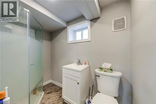 Full bath with a stall shower, vanity, and dark wood finished floors - 142 Ewen Road, Hamilton, ON - Indoor Photo Showing Bathroom