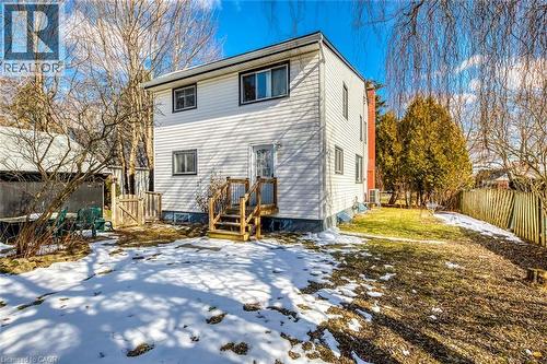 Snow covered house featuring a fenced backyard and a gate - 142 Ewen Road, Hamilton, ON - Outdoor