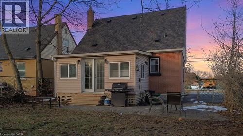 Back of house featuring a patio area, brick siding, a shingled roof, and a chimney - 776 Britannia Avenue, Hamilton, ON - Outdoor