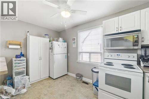 Kitchen with white appliances, white cabinetry, ceiling fan, and light countertops - 776 Britannia Avenue, Hamilton, ON - Indoor Photo Showing Kitchen