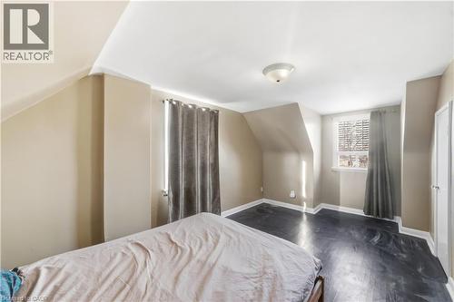 Bedroom featuring lofted ceiling and dark wood-style floors - 776 Britannia Avenue, Hamilton, ON - Indoor Photo Showing Bedroom