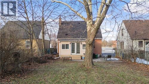 Rear view of property featuring a patio area, a fenced backyard, a shingled roof, and a chimney - 776 Britannia Avenue, Hamilton, ON - Outdoor