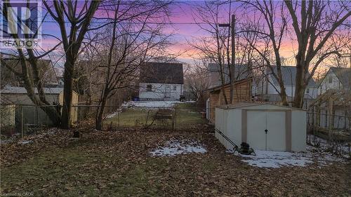 Yard layered in snow featuring a fenced backyard and a storage unit - 776 Britannia Avenue, Hamilton, ON - Outdoor
