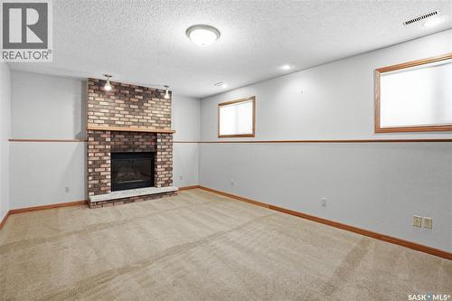 210 Brunst Crescent, Saskatoon, SK - Indoor Photo Showing Living Room With Fireplace