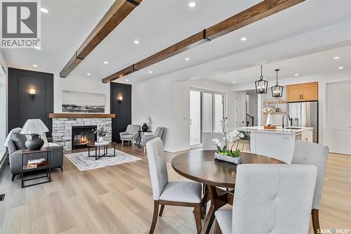 327 Woolf Bay, Saskatoon, SK - Indoor Photo Showing Dining Room With Fireplace