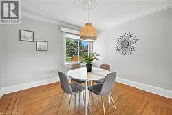 Dining area featuring hardwood / wood-style flooring, ornamental molding, and a textured ceiling - 
