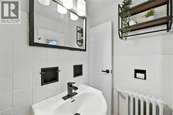 Bathroom with radiator and tile walls - 