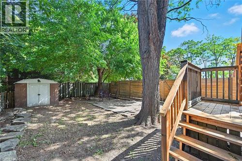Fenced backyard with a storage unit - 1047 Main Street E, Hamilton, ON - Outdoor