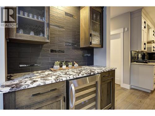 Wine fridge / Wet bar off kitchen and dining area - 5499 Mountainside Drive, Kelowna, BC - Indoor Photo Showing Kitchen With Upgraded Kitchen