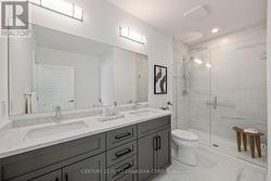 Ensuite with double sinks and glass shower - 