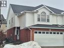 View of home's exterior with brick siding, a shingled roof, and a garage - 10 Donnenwerth Drive, Kitchener, ON  - Outdoor With Exterior 