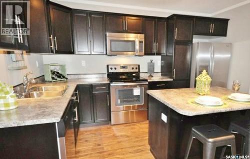 21 10 Clark Drive, Kindersley, SK - Indoor Photo Showing Kitchen With Stainless Steel Kitchen With Double Sink