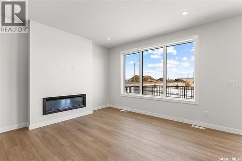 279 Nazarali Way, Saskatoon, SK - Indoor Photo Showing Living Room With Fireplace