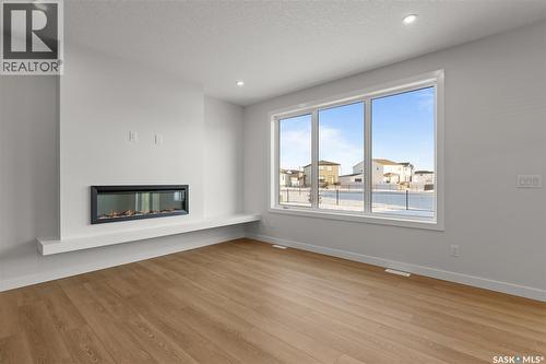 938 Brighton Gate, Saskatoon, SK - Indoor Photo Showing Living Room With Fireplace