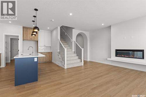 938 Brighton Gate, Saskatoon, SK - Indoor Photo Showing Other Room With Fireplace