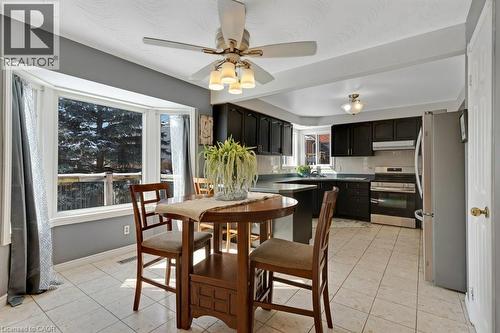 Dining room with a ceiling fan and light tile patterned floors - 148 Cowan Boulevard, Cambridge, ON - Indoor Photo Showing Dining Room