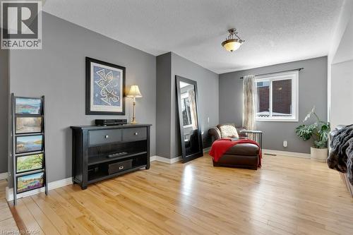 Living area featuring light wood-style floors and a textured ceiling - 148 Cowan Boulevard, Cambridge, ON - Indoor Photo Showing Living Room